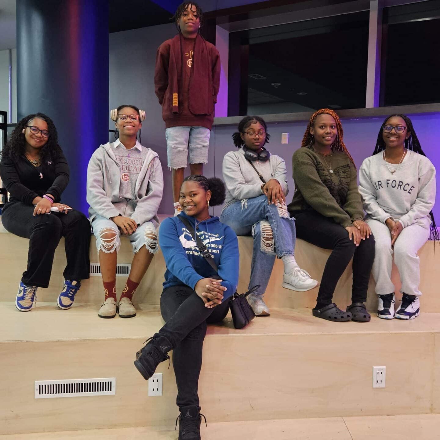A group of children sitting on a stage
