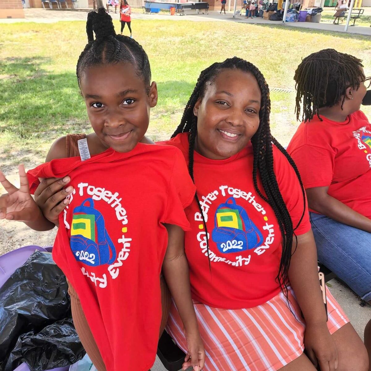 2 teens showing off their t-shirts